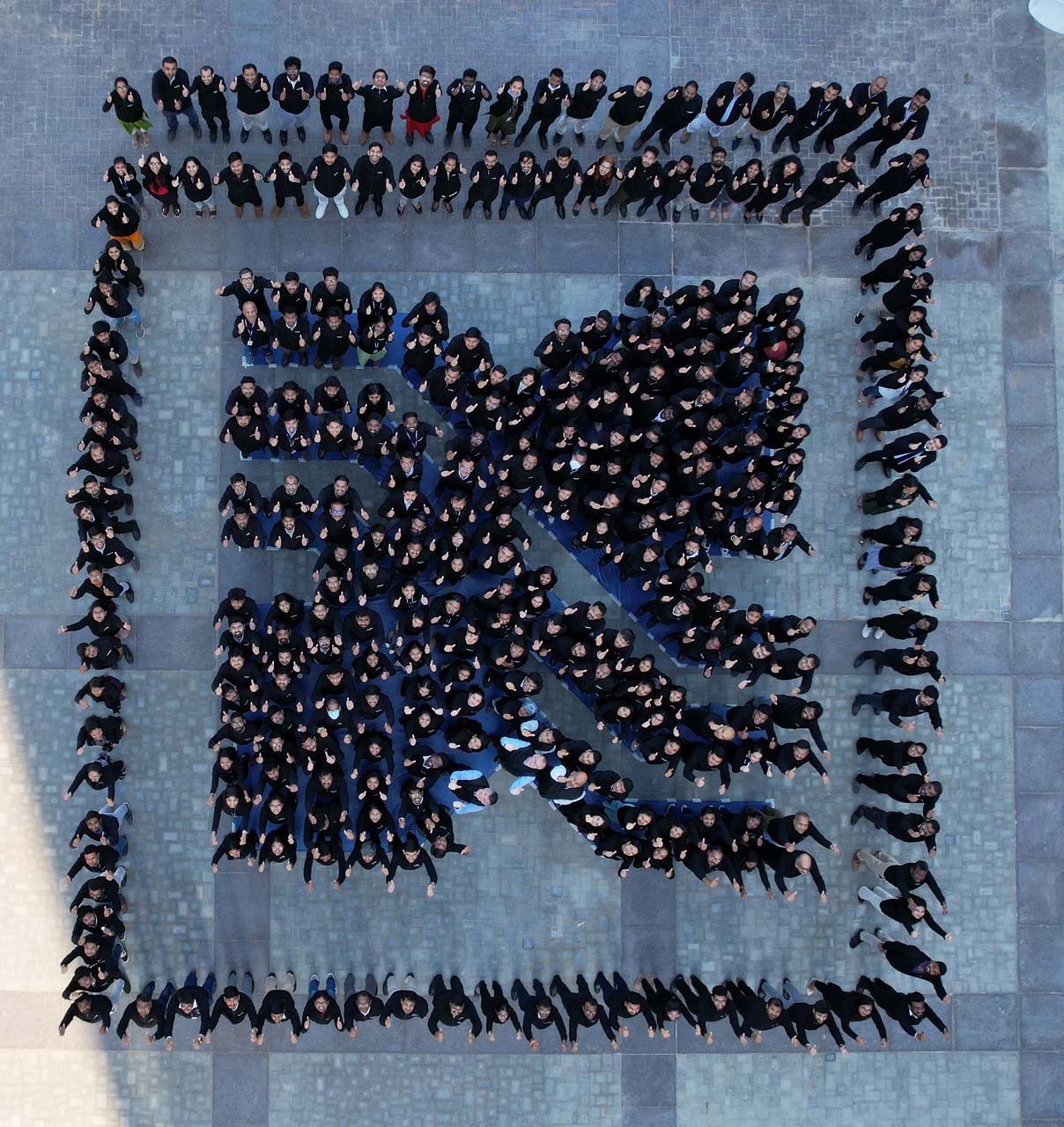 People forming BorgWarner logo