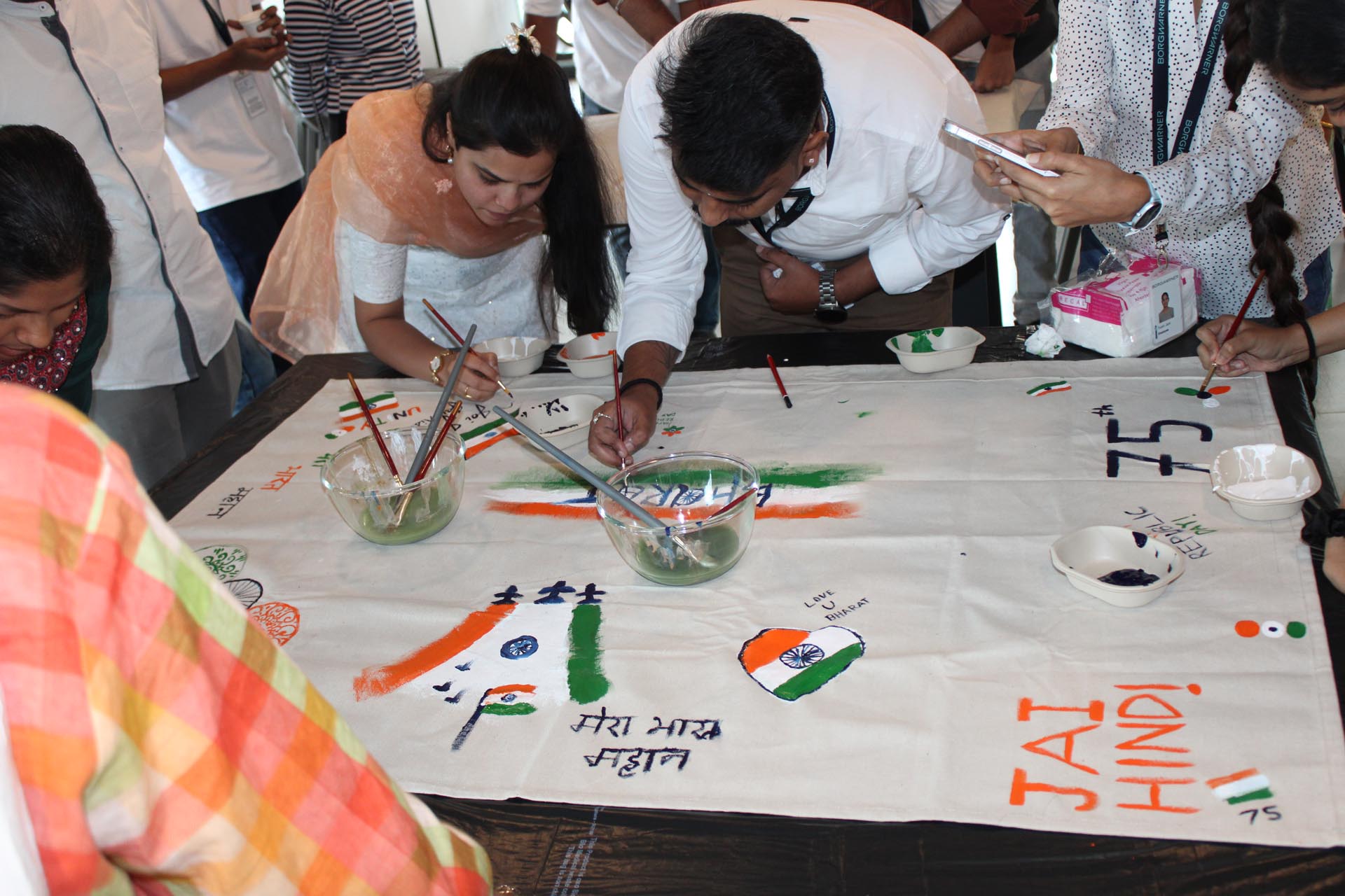A table covered with a cloth featuring the Indian flag and other flags of India, showcasing vibrant colors and designs.