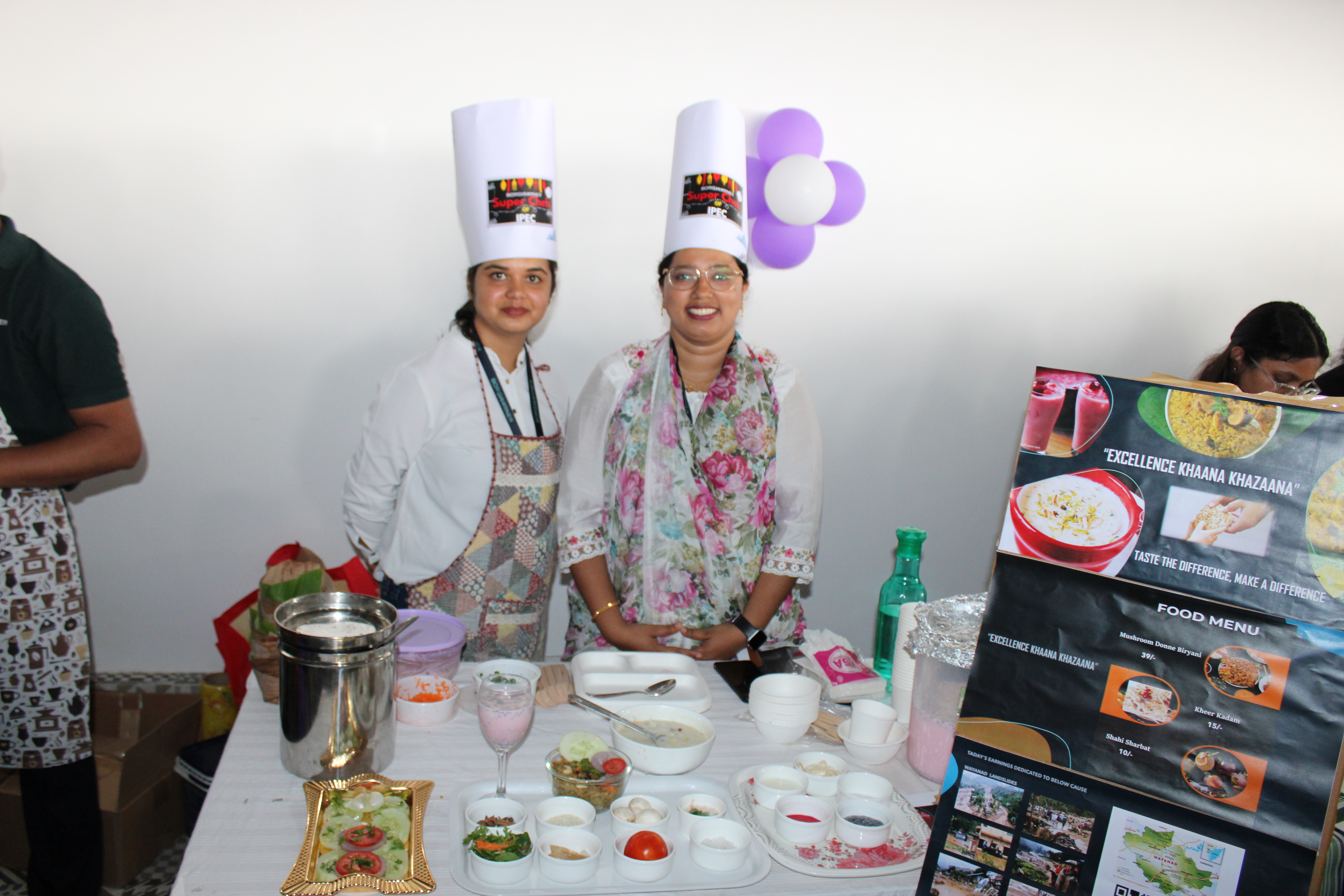 Two women wearing chef hats