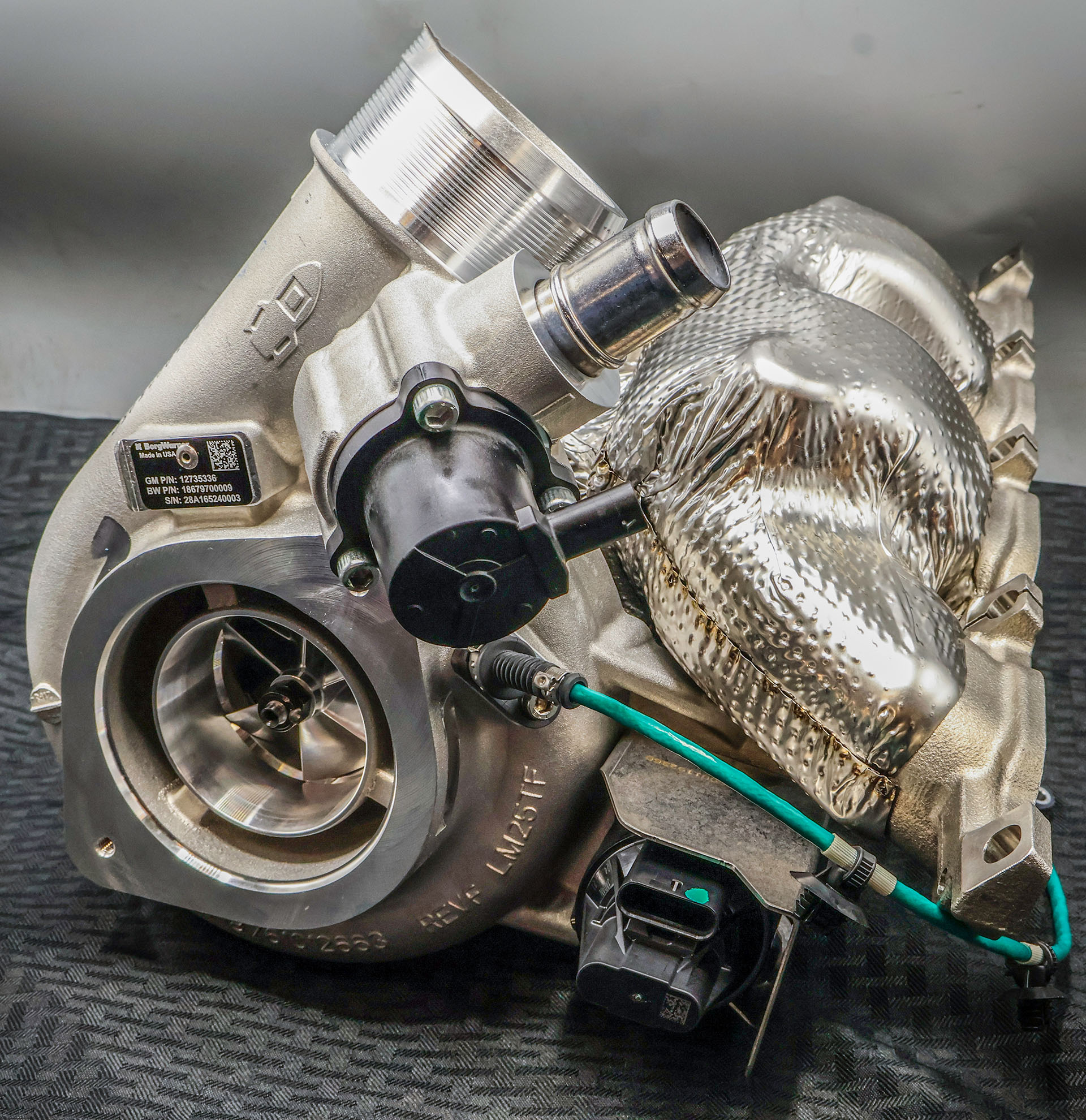 Large silver double turbocharger with grey background