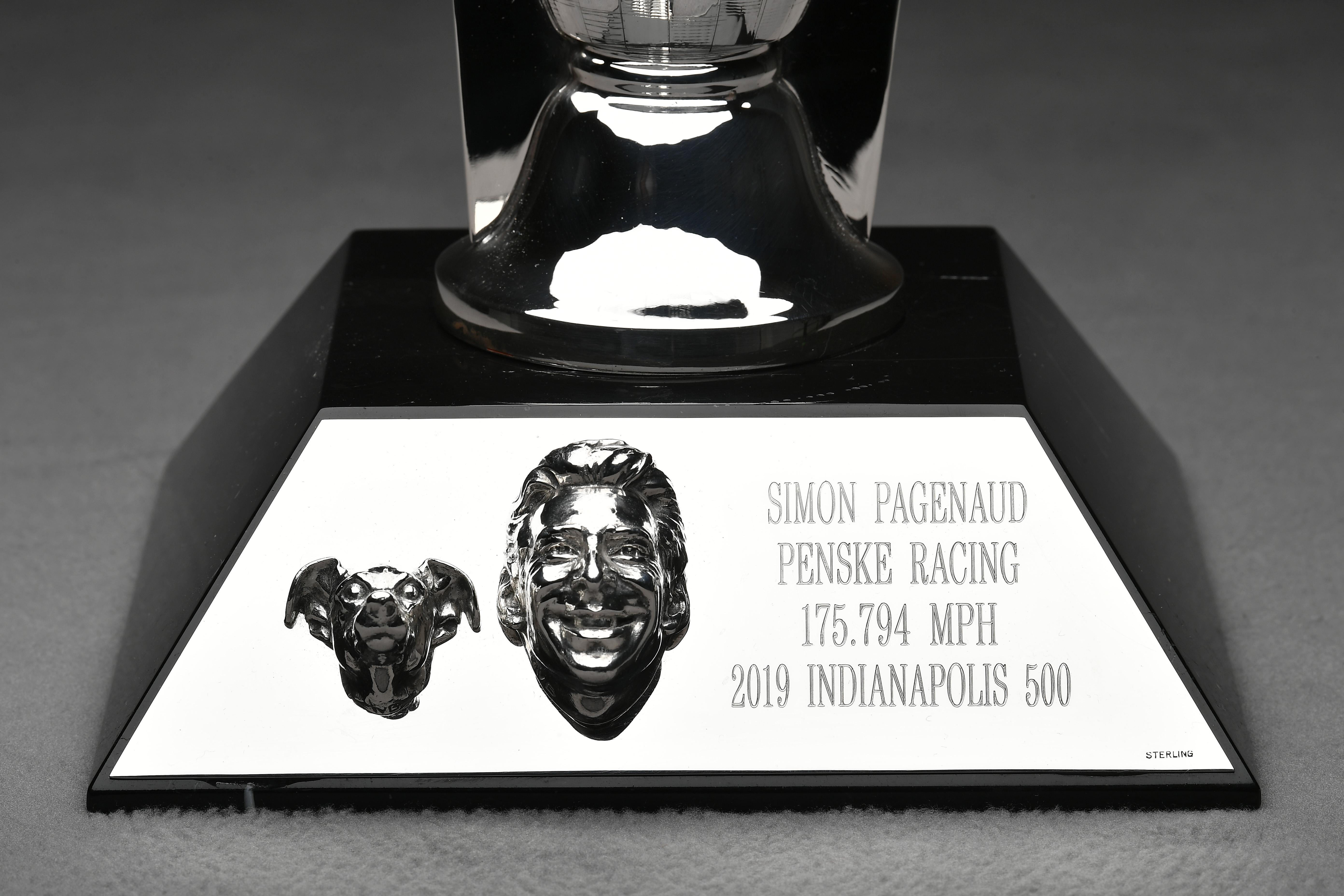 a trophy with a silver base and a silver trophy with a silver and black base