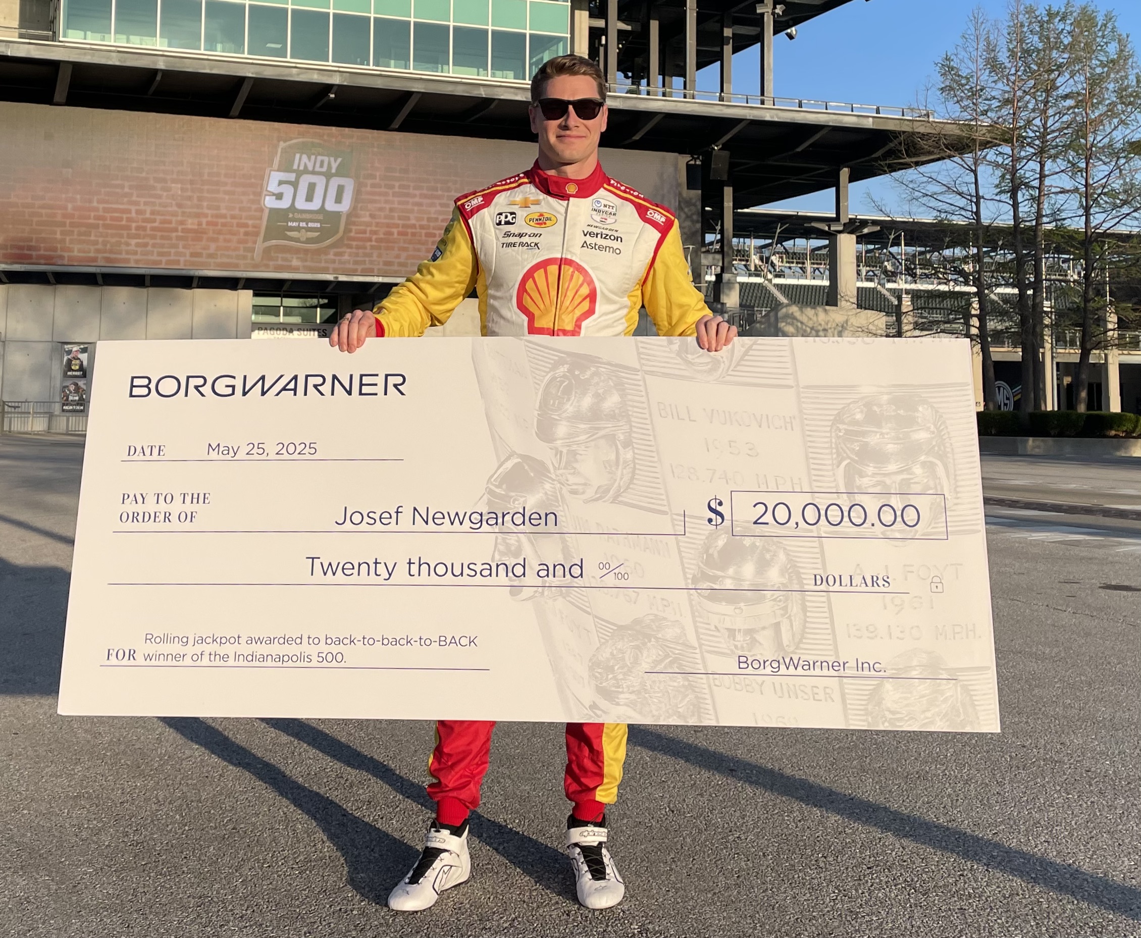 INDYCAR driver Josef Newgarden holds giant check for $20,000