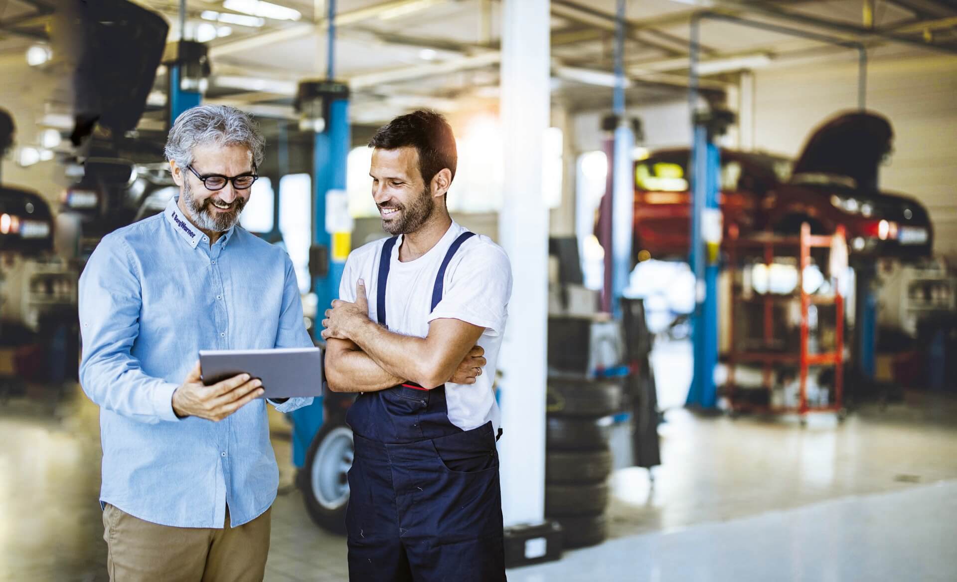 a person and a person looking at a tablet