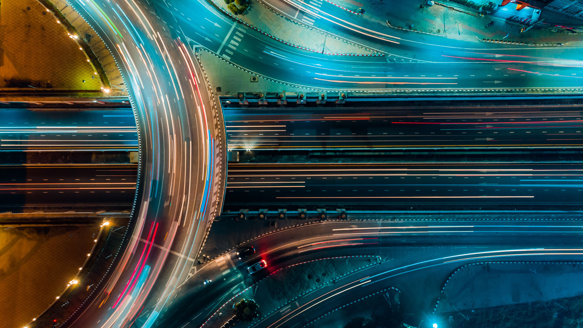 aerial shot of city traffic at night, blurred lights