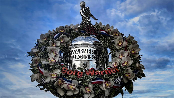 Wreath with greenery and florals around the Borg-Warner Trophy