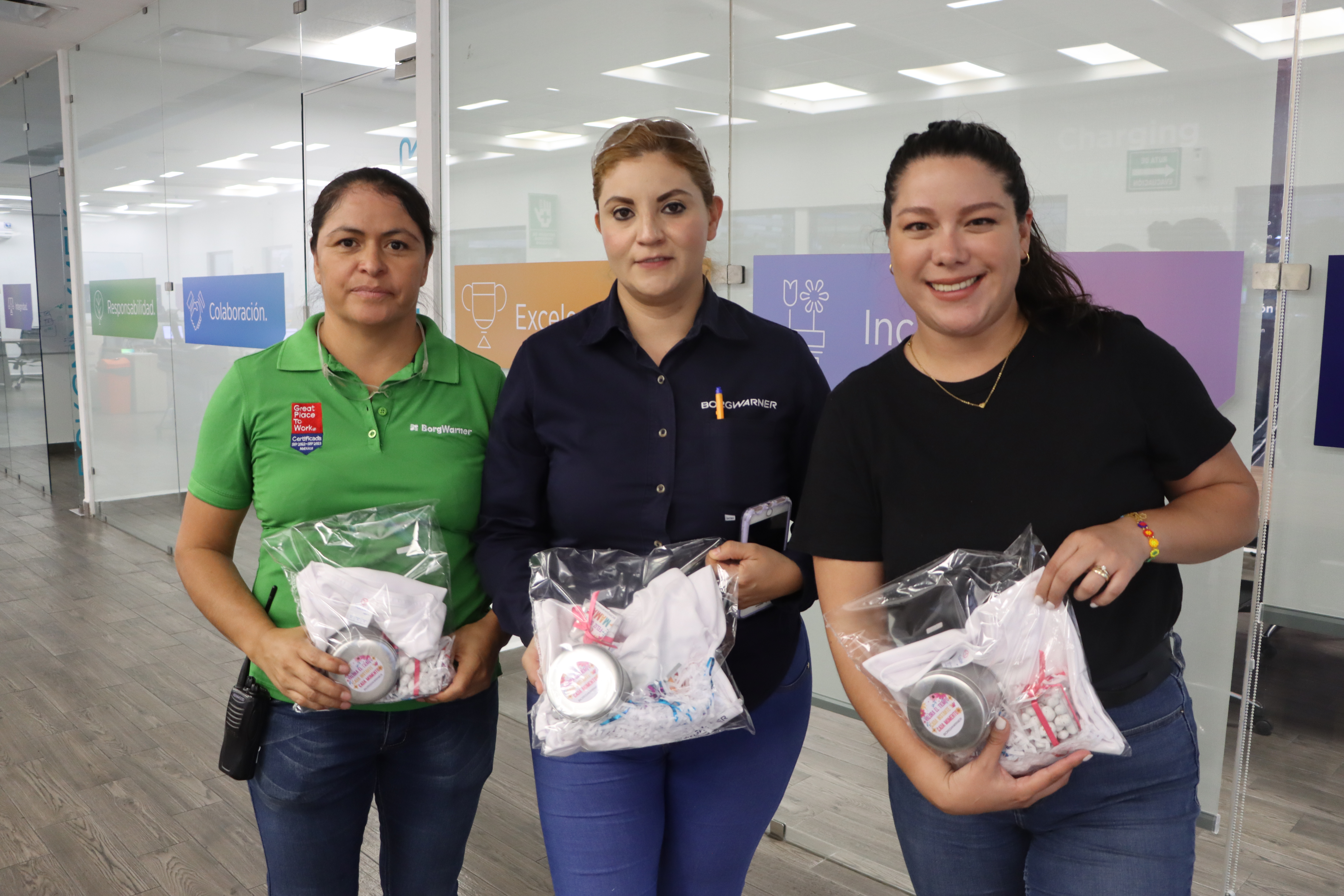 Three women holding plastic bags
