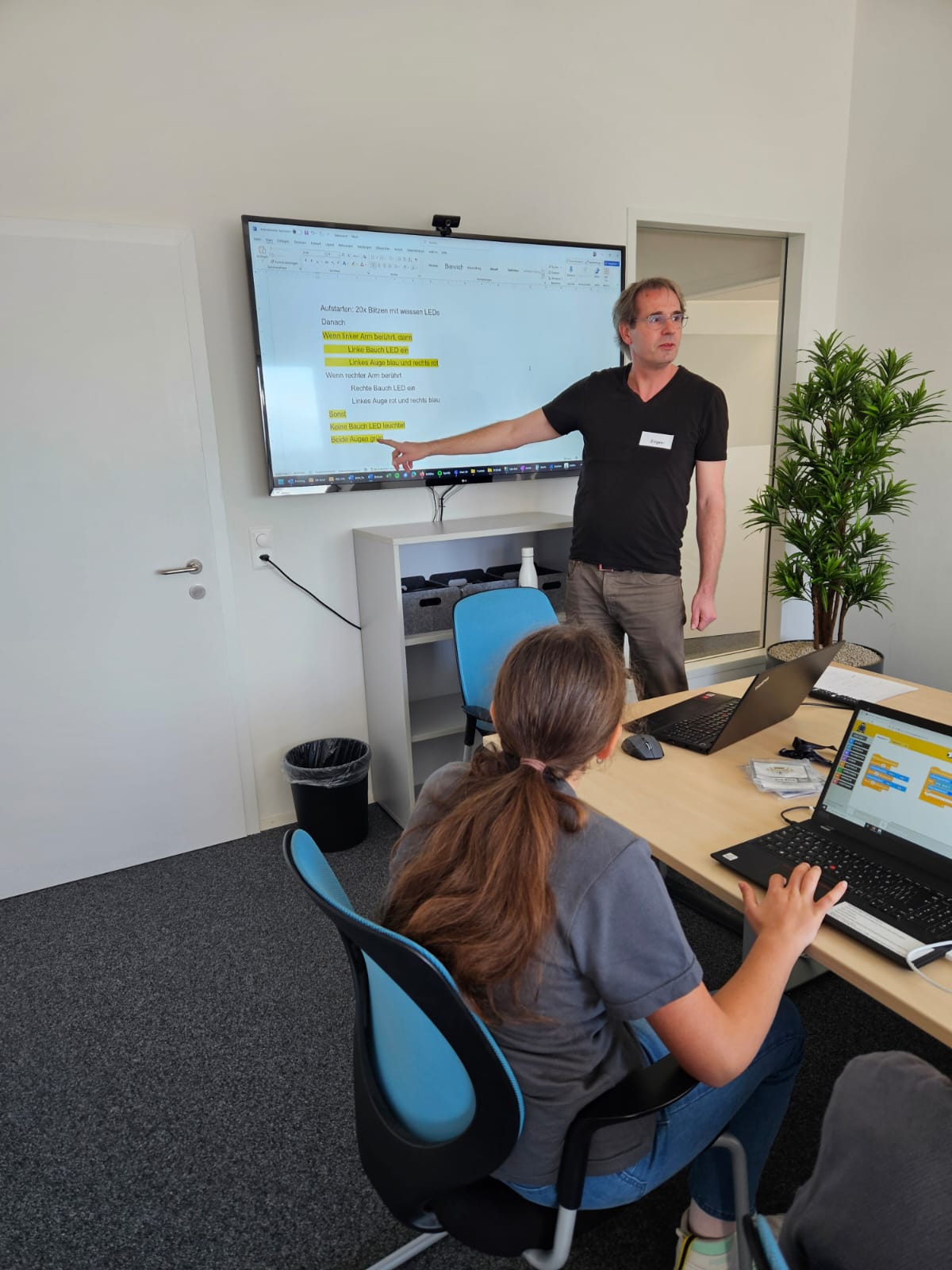 Person pointing to a screen